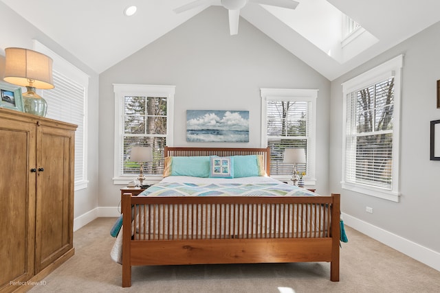 bedroom with ceiling fan, light carpet, high vaulted ceiling, and multiple windows