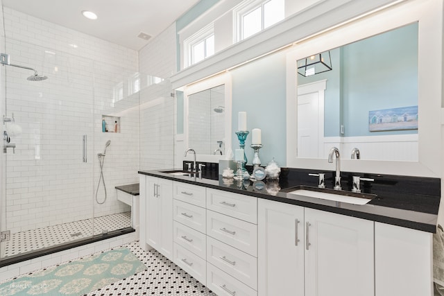 bathroom with vanity, a shower with shower door, and tile patterned floors