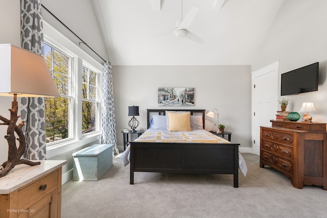 carpeted bedroom featuring lofted ceiling and ceiling fan