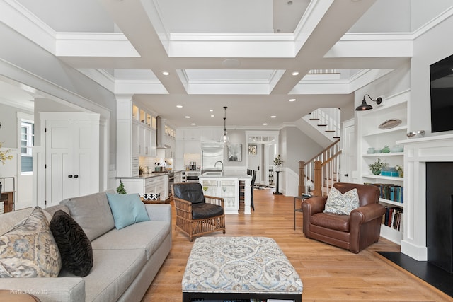 living room featuring coffered ceiling, light hardwood / wood-style flooring, and beam ceiling