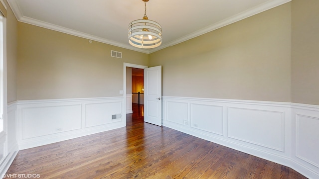 unfurnished room with crown molding, hardwood / wood-style flooring, and a notable chandelier