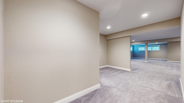 basement featuring light colored carpet