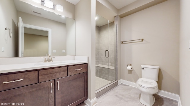 bathroom featuring vanity, toilet, an enclosed shower, and tile patterned floors