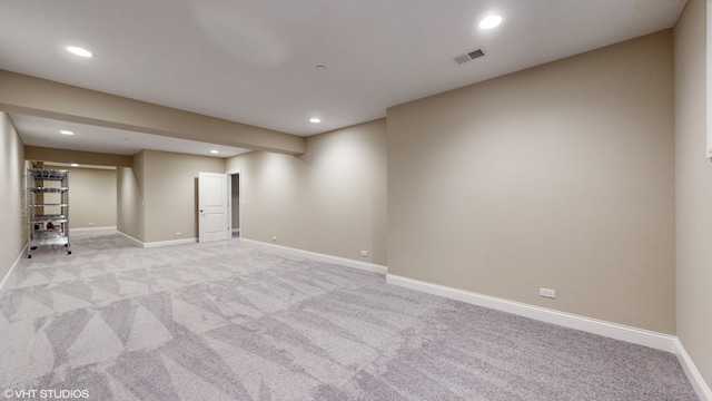 basement featuring light colored carpet