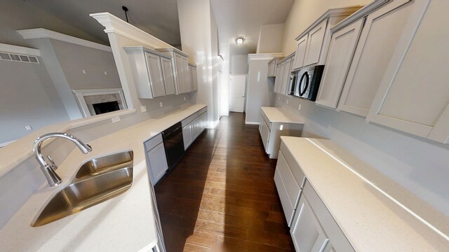 kitchen with vaulted ceiling, decorative light fixtures, and sink