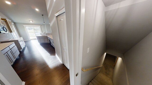 carpeted spare room with ceiling fan and vaulted ceiling