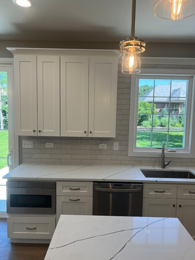 kitchen featuring appliances with stainless steel finishes, plenty of natural light, and sink