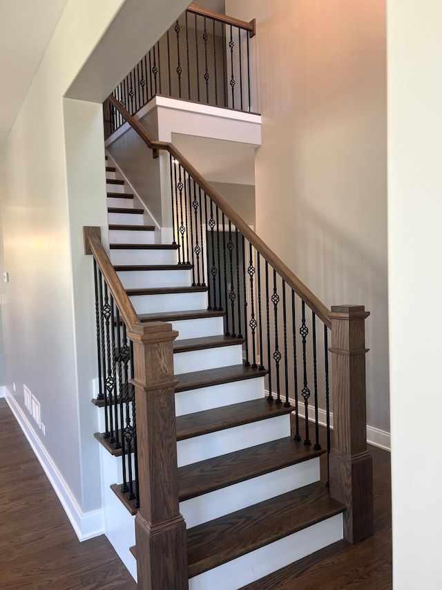 staircase with hardwood / wood-style flooring