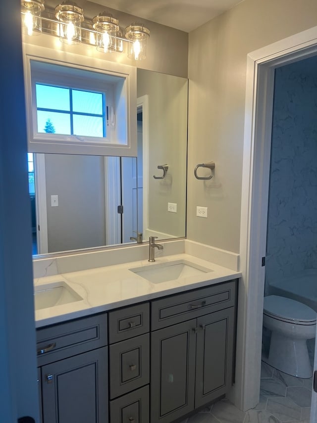 full bathroom featuring vanity, toilet, and  shower combination