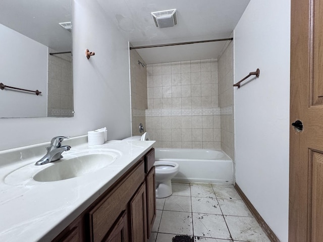 full bathroom featuring tile patterned floors, toilet, vanity, and tiled shower / bath