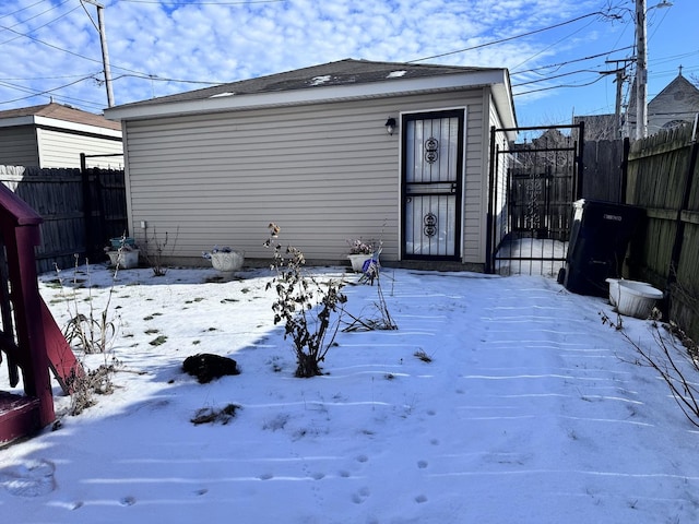 view of snow covered rear of property