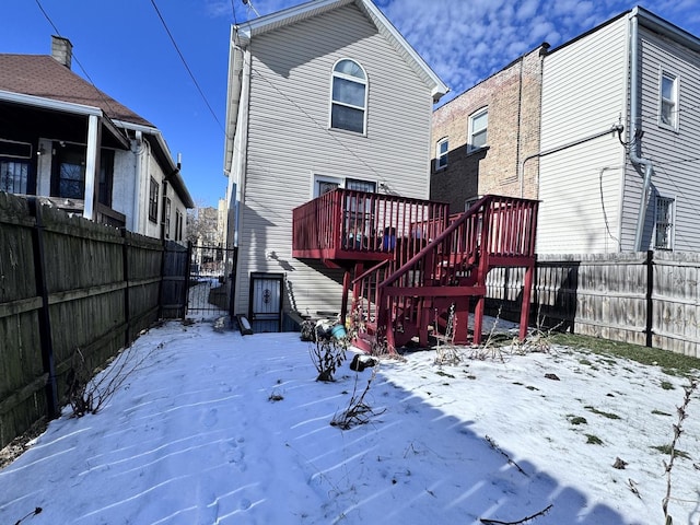 snow covered property featuring a wooden deck