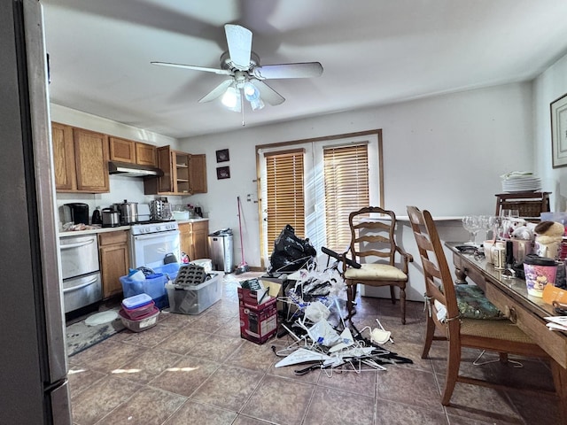 kitchen featuring ceiling fan and dark tile patterned floors