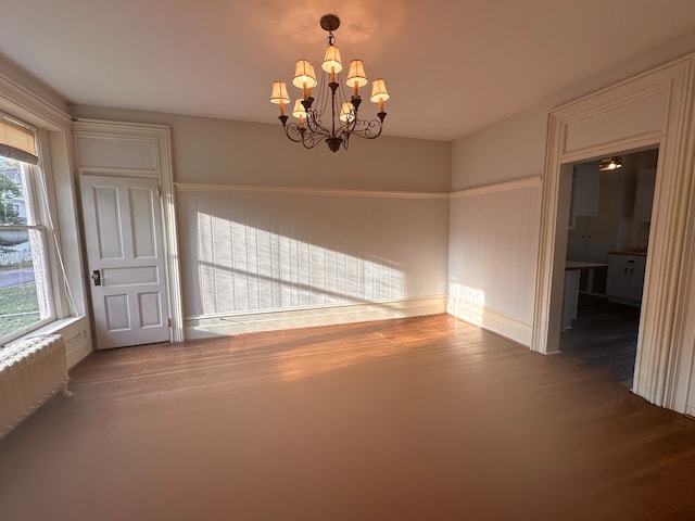 unfurnished room with a notable chandelier