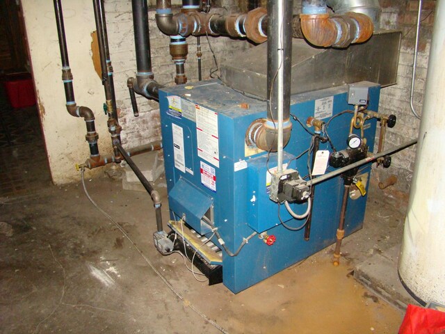 utility room featuring heating unit