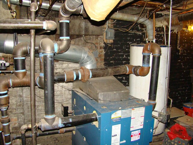 utility room featuring gas water heater