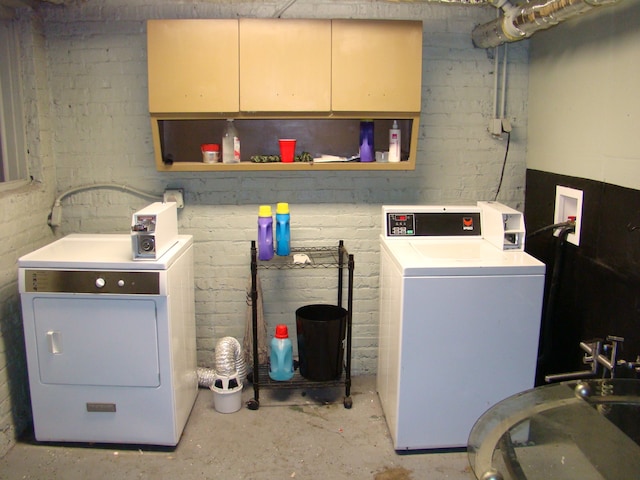 laundry room featuring cabinets and washer and dryer