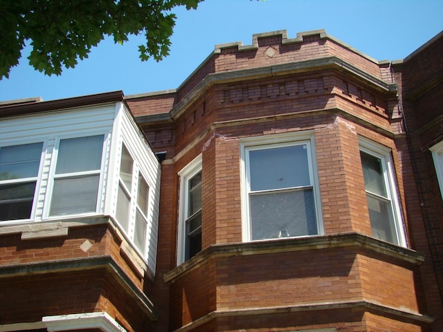 view of property exterior featuring brick siding