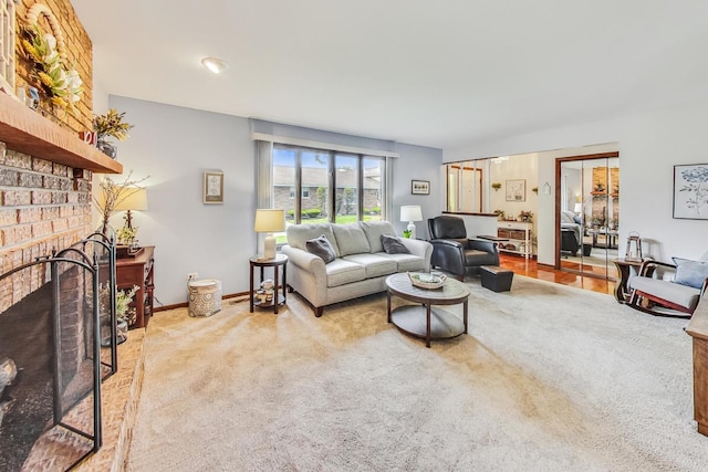 living room with light carpet and a brick fireplace