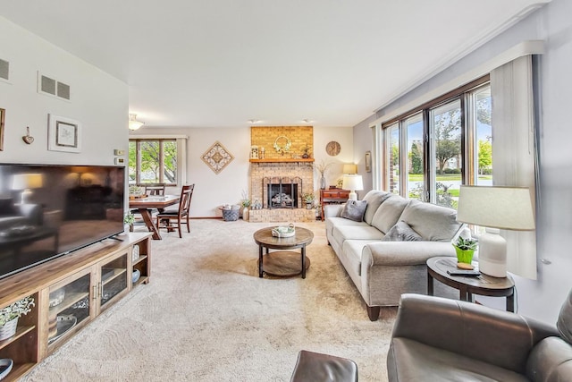 living room featuring light colored carpet and a fireplace