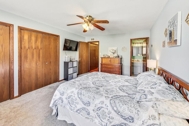 carpeted bedroom with ceiling fan, sink, and ensuite bath