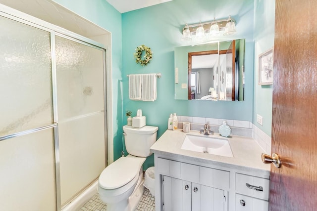 bathroom featuring toilet, a shower with door, and vanity