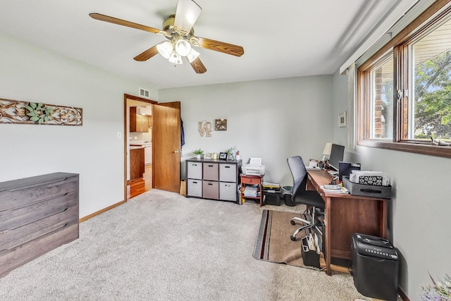 carpeted office featuring ceiling fan