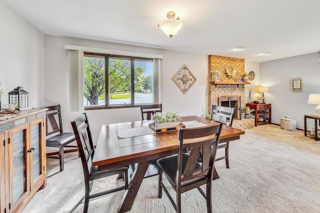 dining room with a fireplace and carpet floors