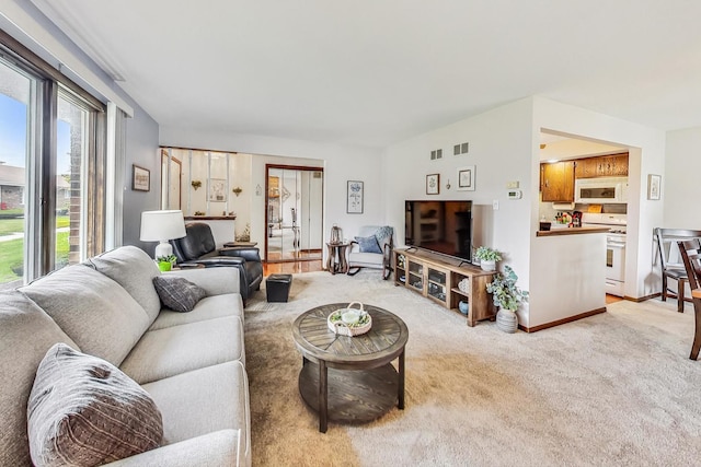 carpeted living room with a healthy amount of sunlight