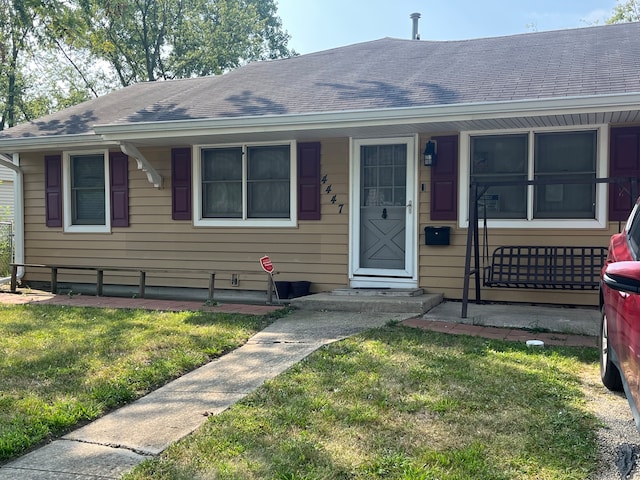 bungalow-style home with a front lawn and a porch