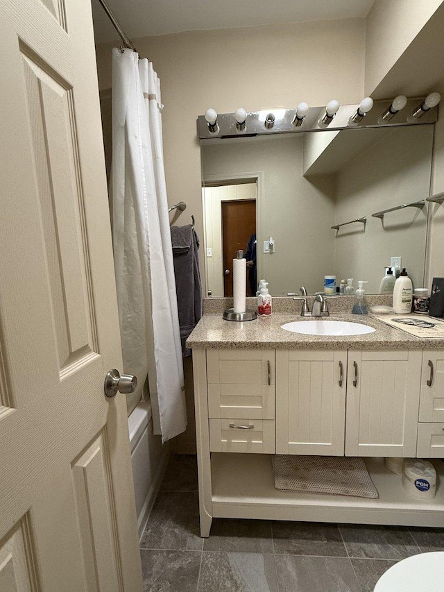 full bathroom with toilet, vanity, and shower / tub combo