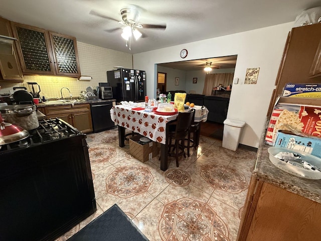 tiled dining space with ceiling fan and sink