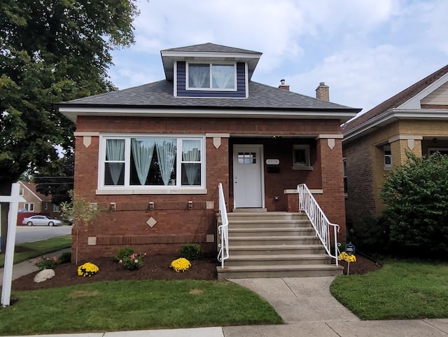 bungalow-style house with a porch and a front lawn