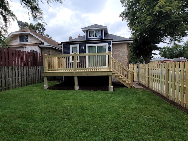 back of property featuring a yard and a deck