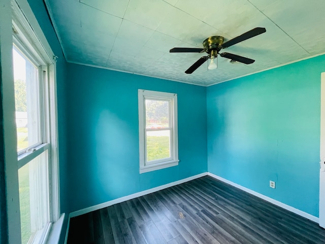 spare room with ceiling fan, wood-type flooring, and a healthy amount of sunlight