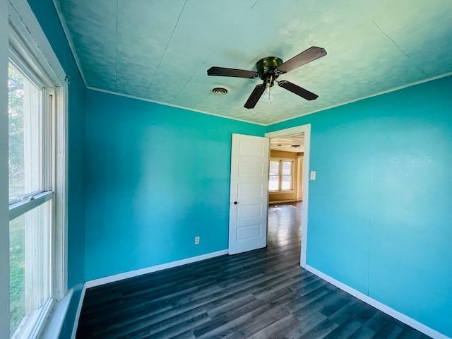 spare room featuring ceiling fan and dark hardwood / wood-style flooring