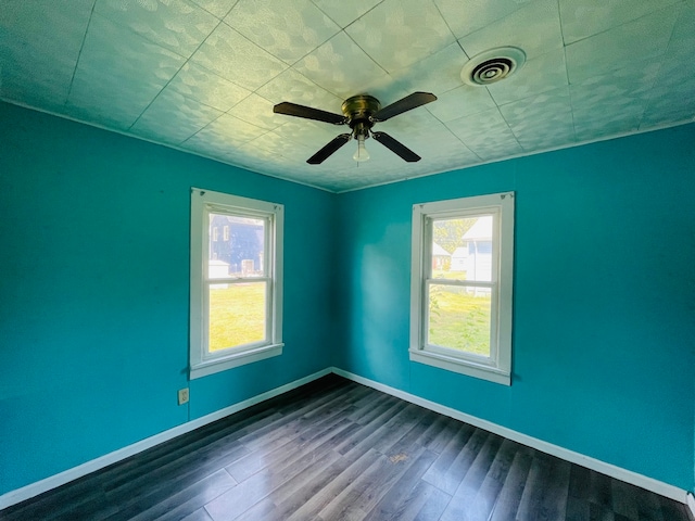 spare room featuring ceiling fan and dark hardwood / wood-style flooring