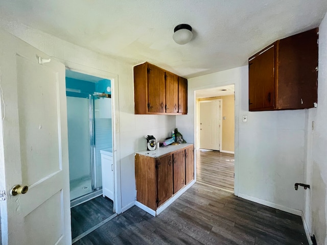 kitchen featuring dark hardwood / wood-style flooring and a textured ceiling