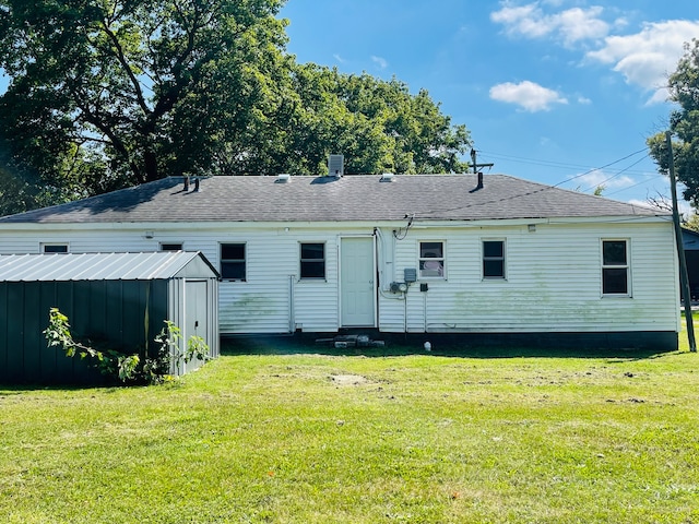 back of property with a lawn and a shed