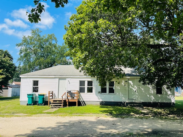 back of house with a yard and a wooden deck