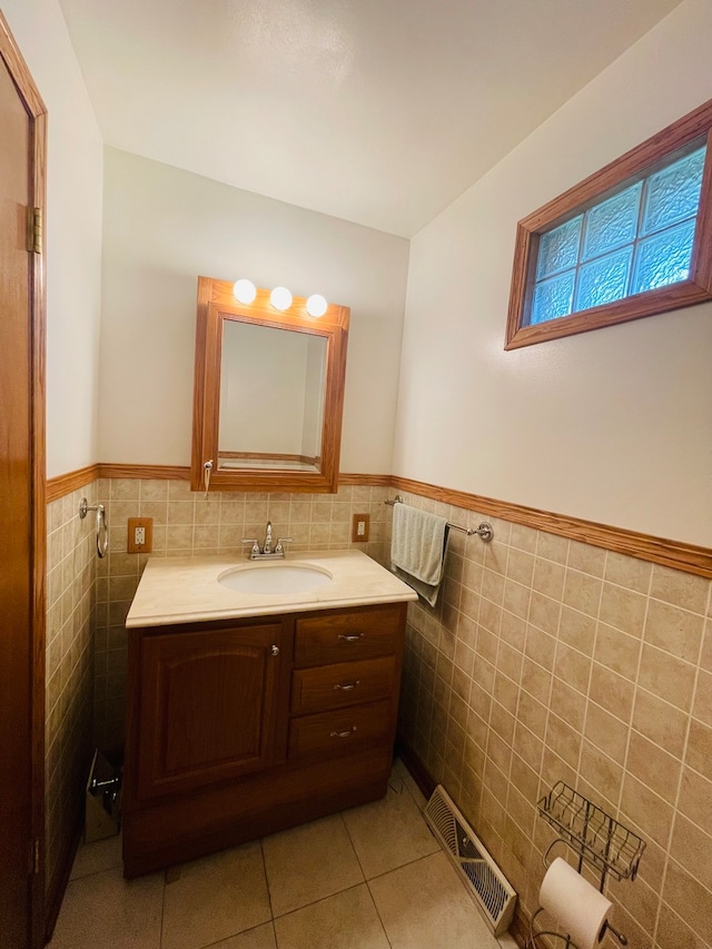 bathroom with tile walls, tile patterned flooring, decorative backsplash, and vanity