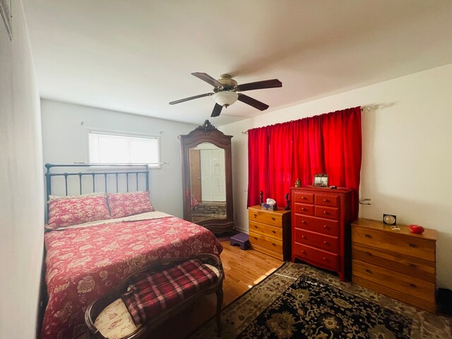 bedroom with hardwood / wood-style floors and ceiling fan