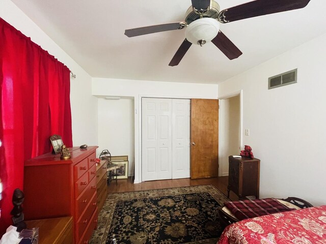 bedroom with ceiling fan, a closet, and hardwood / wood-style flooring