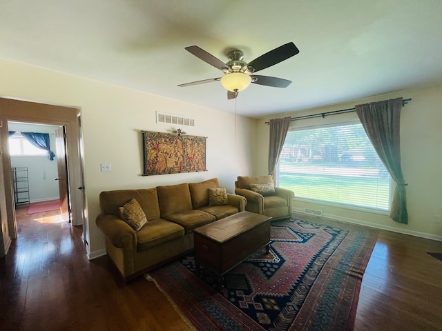 living room with ceiling fan and dark hardwood / wood-style flooring