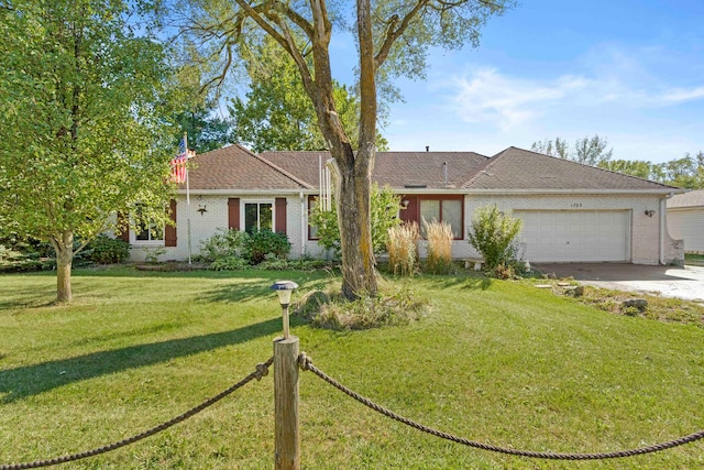 ranch-style house featuring a front yard and a garage