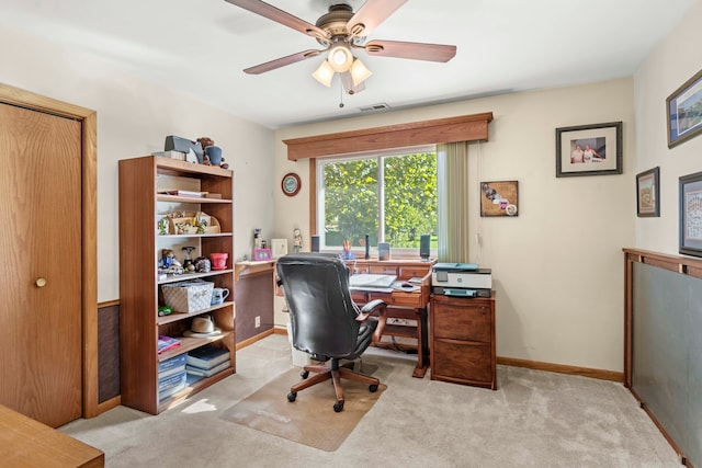 carpeted office featuring ceiling fan