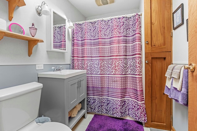 bathroom with curtained shower, tile patterned flooring, vanity, and toilet