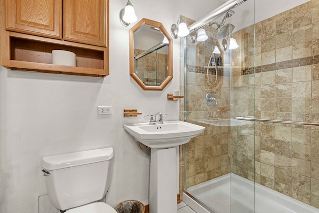 bathroom with an enclosed shower and toilet