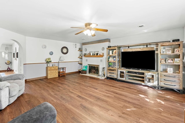 living room featuring ceiling fan and hardwood / wood-style floors