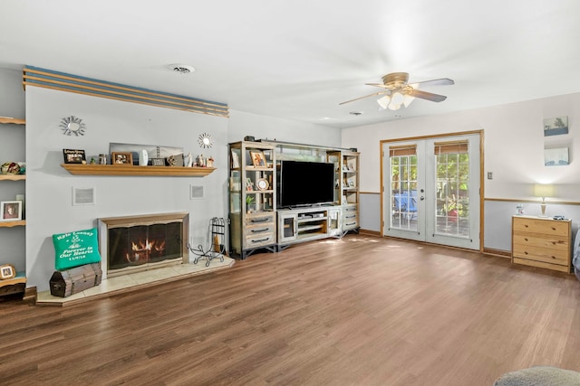 unfurnished living room featuring ceiling fan, french doors, and hardwood / wood-style flooring